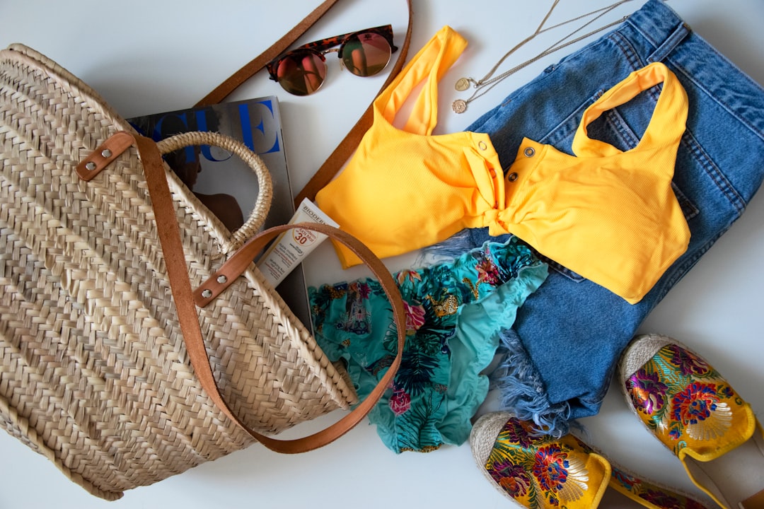 Lightweight sundresses and sandals laid out for beach packing