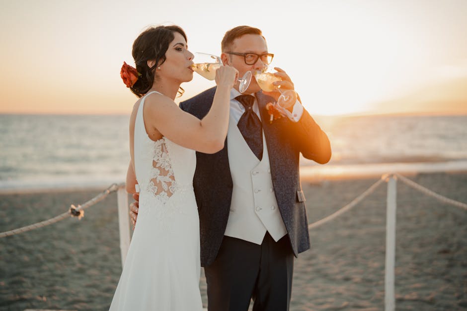 Newlyweds toasting with champagne on a Caribbean white sand beach