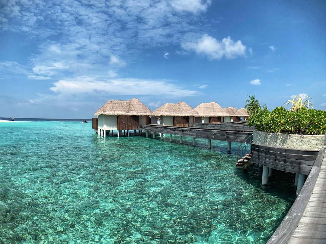 Luxury overwater bungalow surrounded by turquoise water in the Maldives