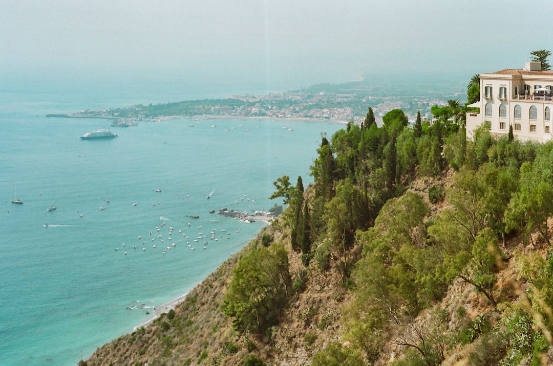 Elegant outdoor destination wedding ceremony at a scenic coastal villa