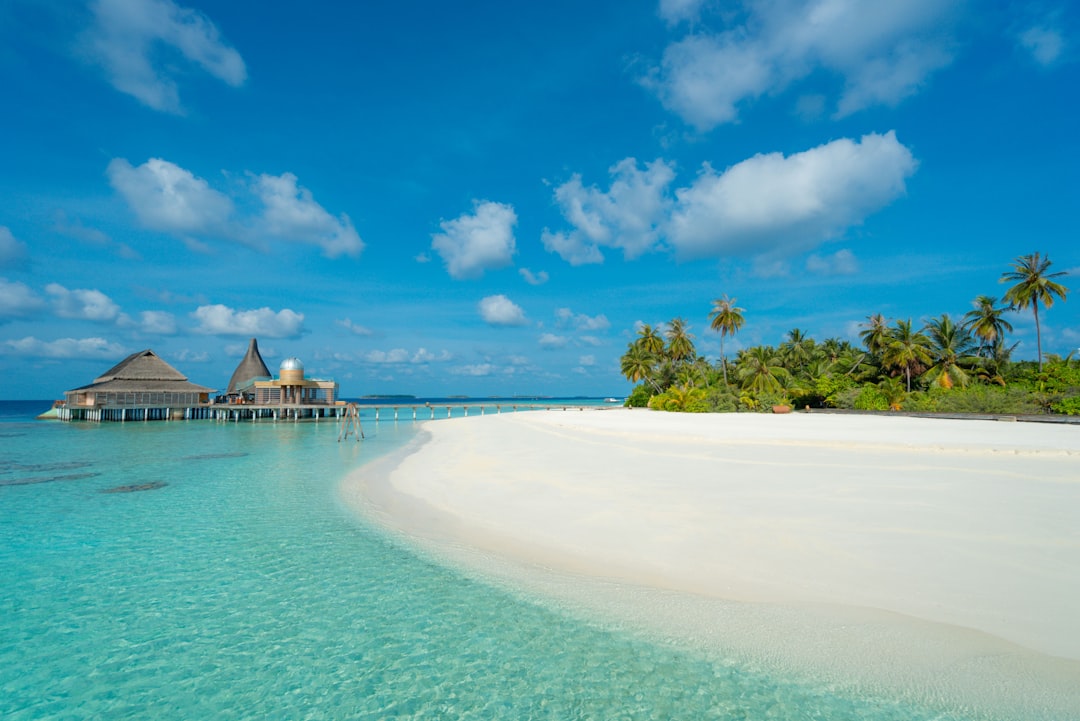 Overwater bungalows surrounded by turquoise Maldives lagoon