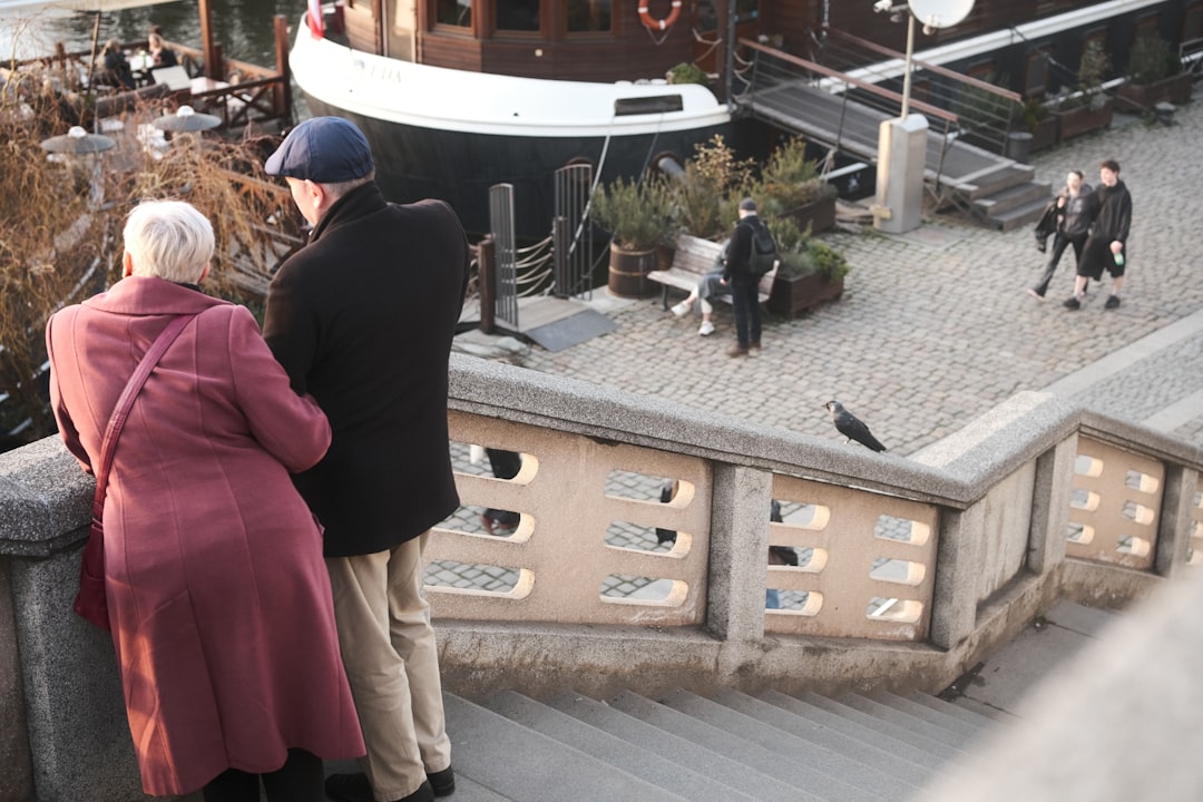 Couple walking hand in hand on a romantic European cobblestone street